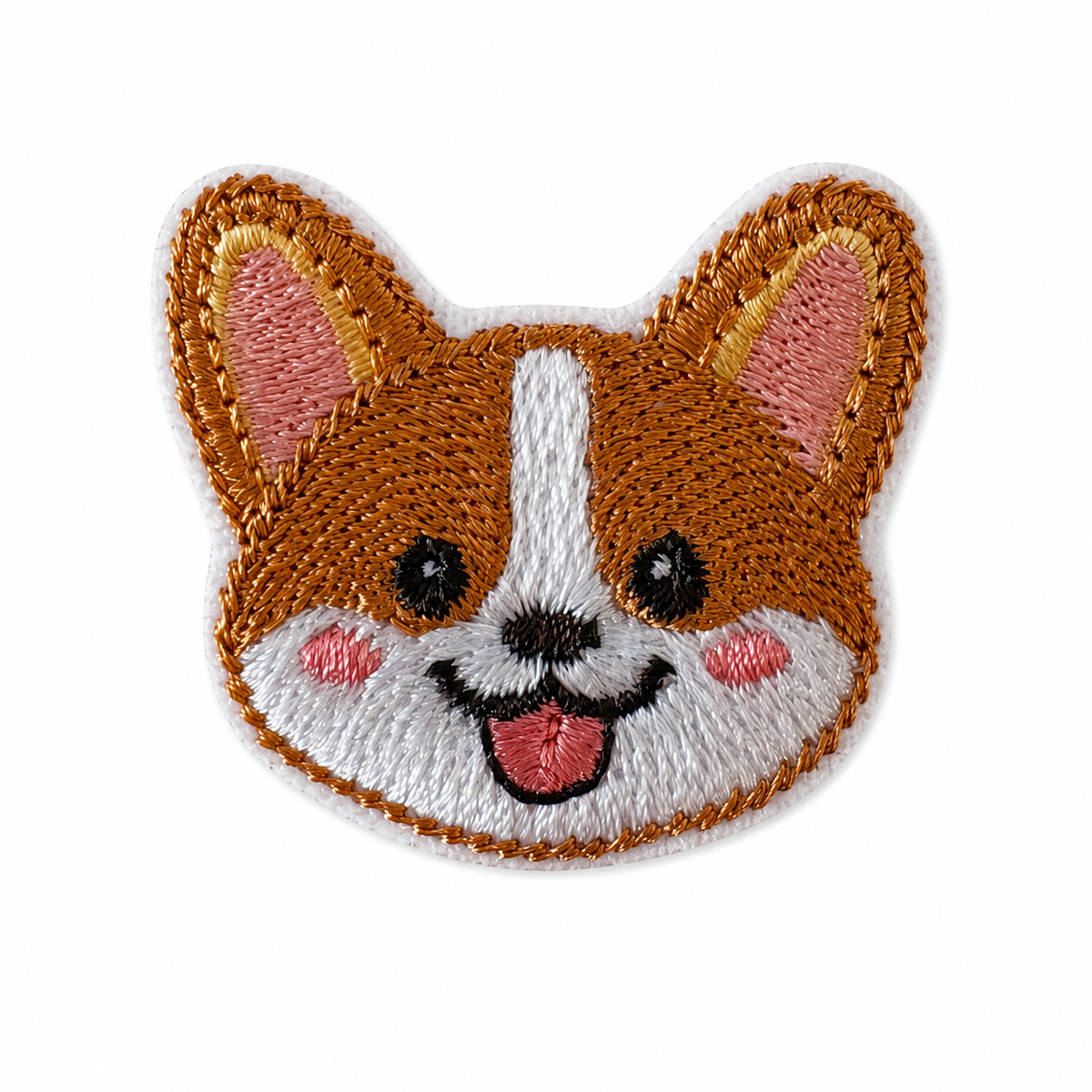 An embroidered patch shaped like a corgi dog face, featuring brown and white fur with pink inner ears, cheeks, and tongue, and black embroidered eyes and nose, shown on a plain white background.