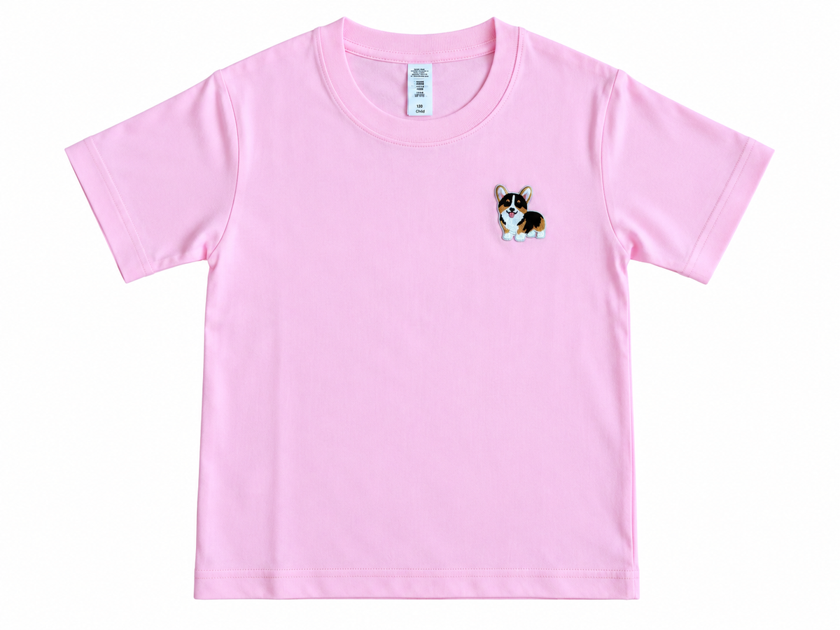 A light pink short-sleeve kids' t-shirt with a small embroidered corgi dog on the left chest, displayed flat against a white background.
