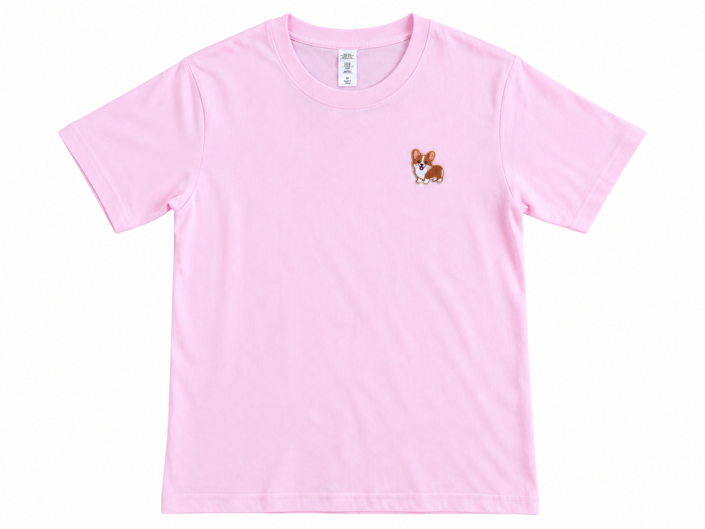 A light pink short-sleeve crewneck t-shirt featuring a small embroidered corgi dog graphic on the left chest, displayed flat against a white background.