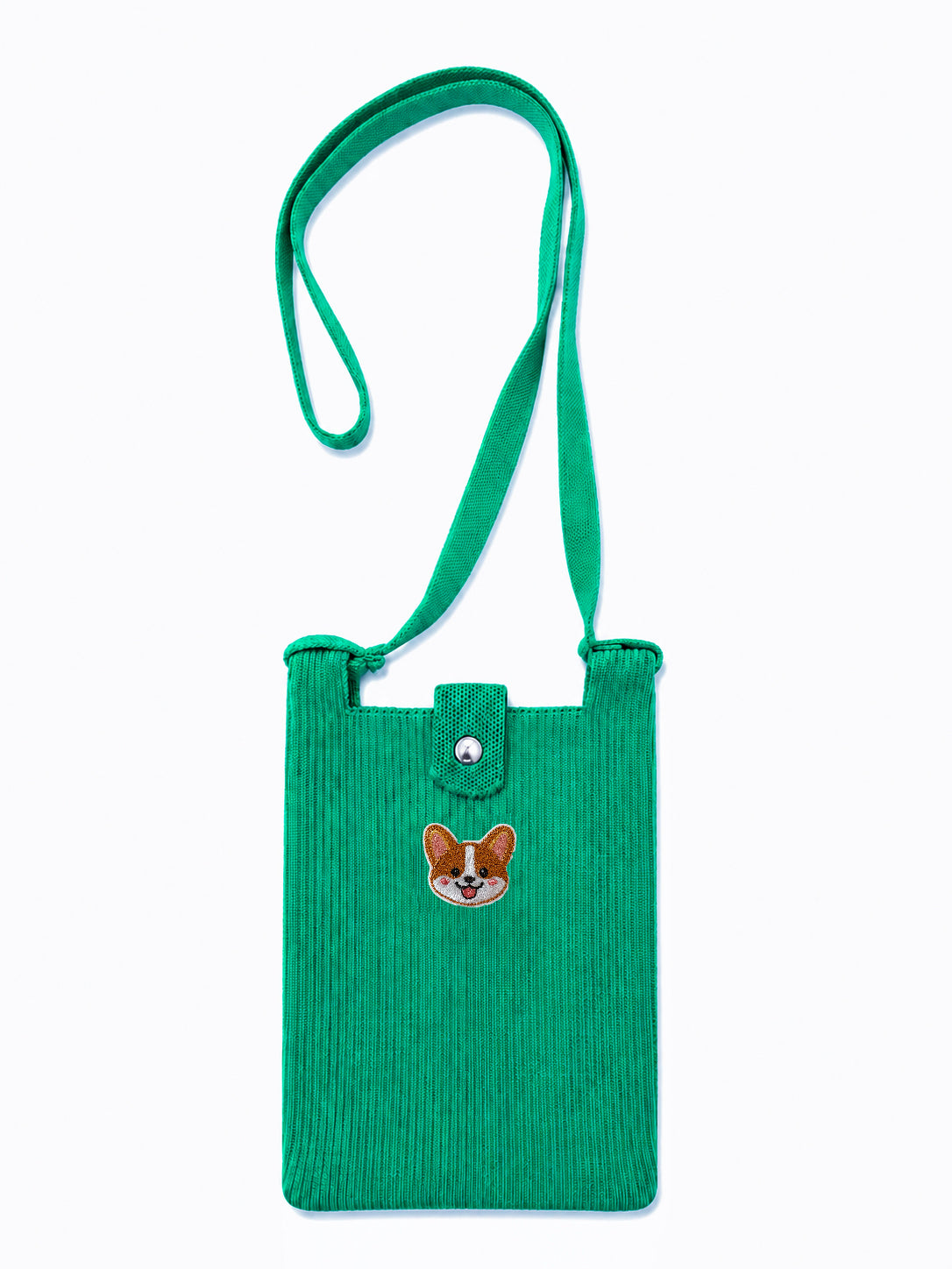 A green corduroy crossbody bag with a matching adjustable shoulder strap, featuring a small embroidered corgi face patch on the front 