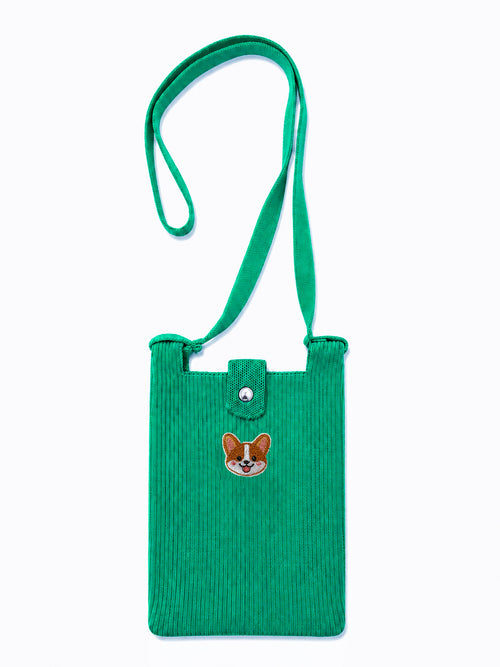 A green corduroy crossbody bag with a matching adjustable shoulder strap, featuring a small embroidered corgi face patch on the front 
